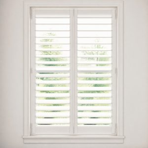 Full-height white plantation shutter with 3.5 inch louvers